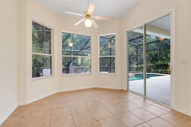 20542 Queen Alexandra Dr, Leesburg, FL 34748 - empty room featuring a sunroom, healthy amount of natural light, light tile patterned floors, and a ceiling fan