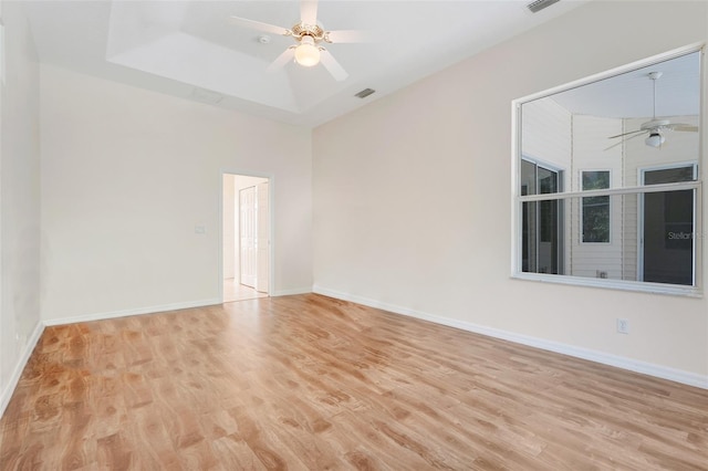 20542 Queen Alexandra Dr, Leesburg, FL 34748 - empty room with ceiling fan, wood finished floors, a tray ceiling, and a towering ceiling
