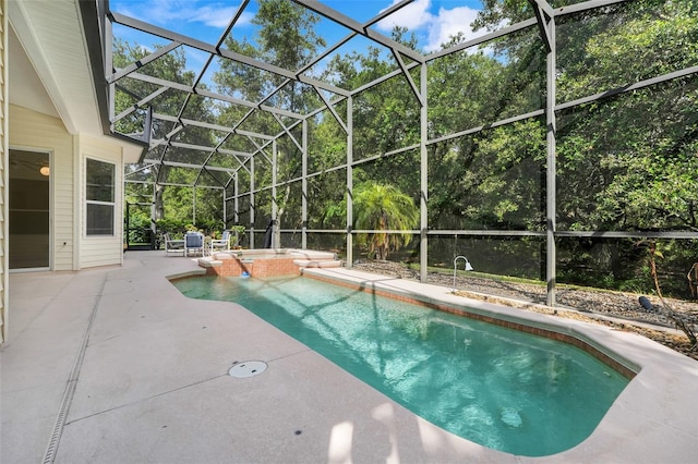 20542 Queen Alexandra Dr, Leesburg, FL 34748 - view of swimming pool featuring a patio area, a pool with connected hot tub, a lanai, and view of wooded area