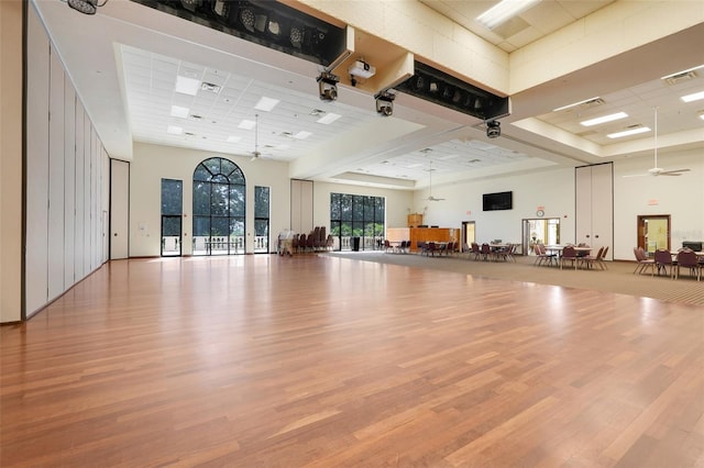 20542 Queen Alexandra Dr, Leesburg, FL 34748 - exercise area with a towering ceiling, wood finished floors, and a ceiling fan