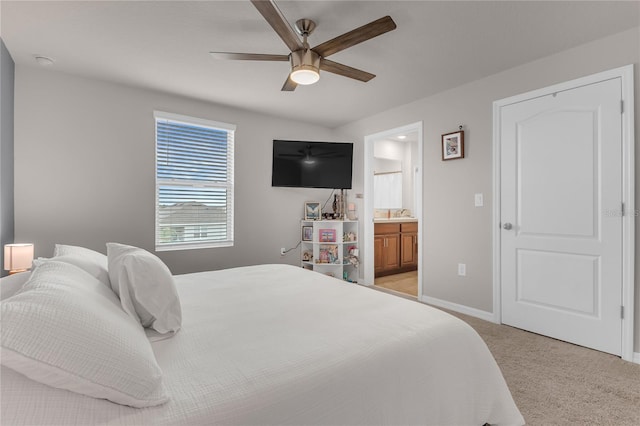 1866 Red Canyon Dr, Kissimmee, FL 34744 - bedroom with light carpet, ensuite bathroom, and a ceiling fan