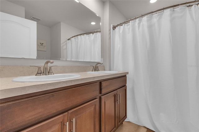 1866 Red Canyon Dr, Kissimmee, FL 34744 - full bath featuring double vanity, tile patterned flooring, recessed lighting, and a shower with shower curtain