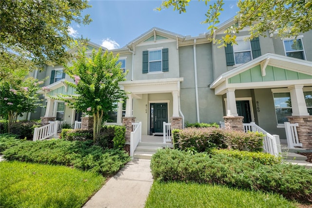 8164 Wood Sage Dr, Winter Garden, FL 34787 - view of front of house featuring stucco siding, stone siding, and covered porch