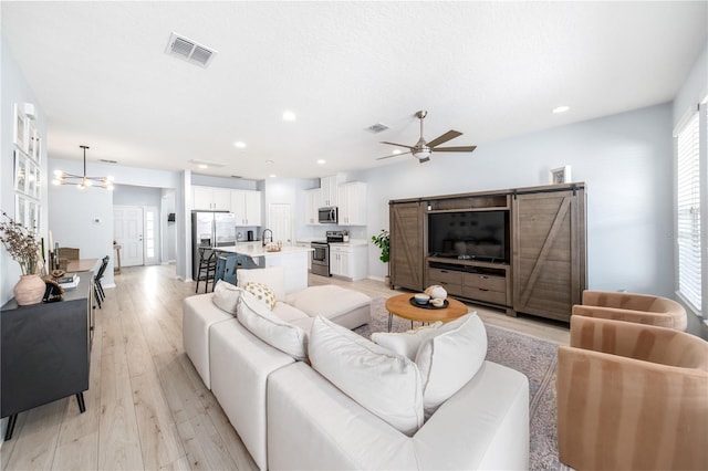 8164 Wood Sage Dr, Winter Garden, FL 34787 - living area with a ceiling fan, light wood-style floors, recessed lighting, and a chandelier