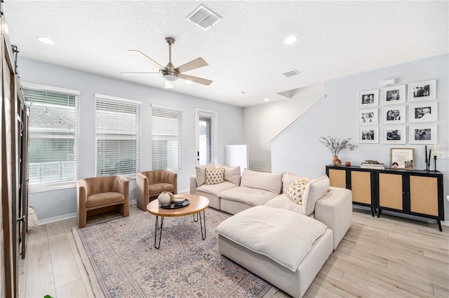 8164 Wood Sage Dr, Winter Garden, FL 34787 - living room featuring ceiling fan, light wood finished floors, a textured ceiling, and recessed lighting