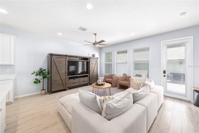 8164 Wood Sage Dr, Winter Garden, FL 34787 - living area with a ceiling fan, light wood-style floors, healthy amount of natural light, a textured ceiling, and recessed lighting