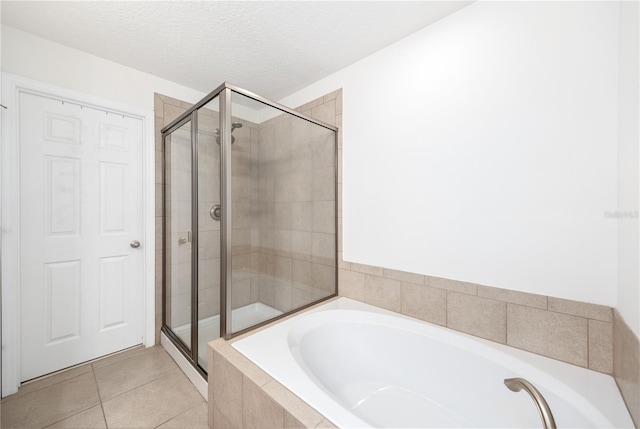 8164 Wood Sage Dr, Winter Garden, FL 34787 - full bath featuring a bath, a stall shower, tile patterned flooring, and a textured ceiling