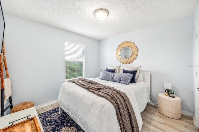 8164 Wood Sage Dr, Winter Garden, FL 34787 - bedroom featuring light wood-type flooring and a textured ceiling