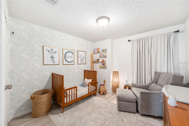 8164 Wood Sage Dr, Winter Garden, FL 34787 - bedroom with wallpapered walls, wood finished floors, and a textured ceiling