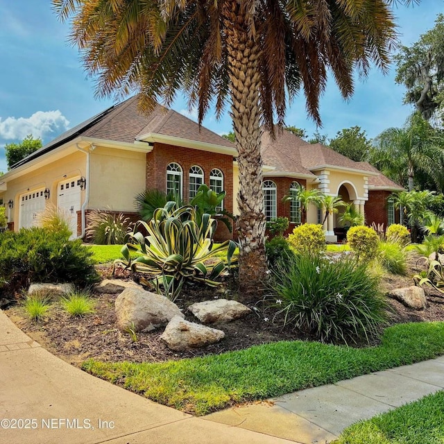 8 Ivey Ln, Flagler Beach, FL 32136 - view of front of property with a garage and stucco siding