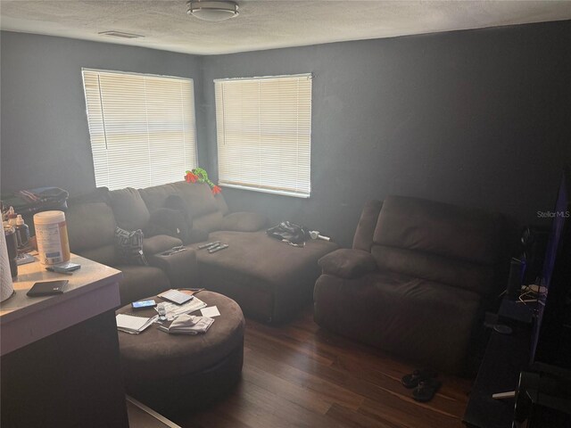 4035 Nimons St, Orlando, FL 32811 - living room featuring wood finished floors, an office area, and a textured ceiling
