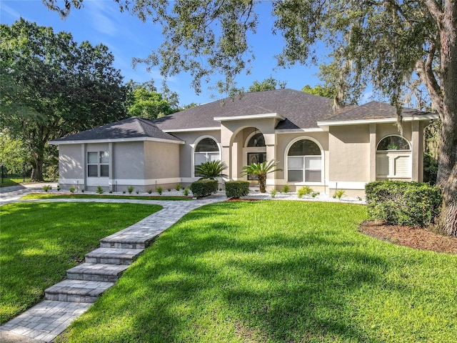 704 Forest View Ct, Winter Springs, FL 32708 - view of front of property with stucco siding, a front lawn, and roof with shingles