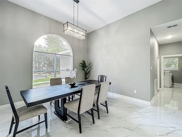 704 Forest View Ct, Winter Springs, FL 32708 - dining space featuring light marble finish floors and a chandelier