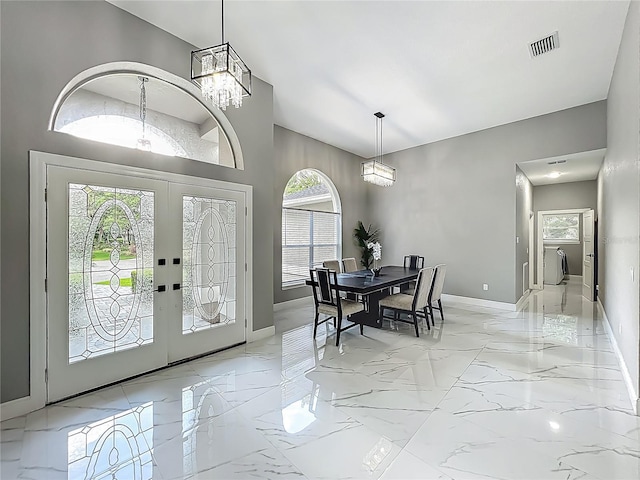 704 Forest View Ct, Winter Springs, FL 32708 - entrance foyer with plenty of natural light, light marble finish floors, french doors, a chandelier, and high vaulted ceiling