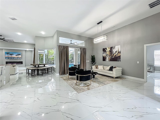 704 Forest View Ct, Winter Springs, FL 32708 - living room with ceiling fan, light marble finish floors, a towering ceiling, and recessed lighting