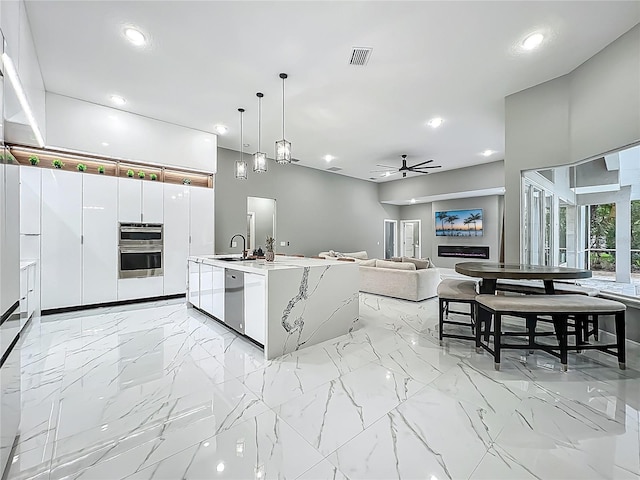 704 Forest View Ct, Winter Springs, FL 32708 - kitchen with appliances with stainless steel finishes, recessed lighting, pendant lighting, ceiling fan, and light countertops