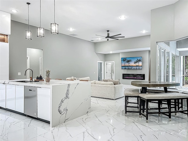 704 Forest View Ct, Winter Springs, FL 32708 - kitchen featuring stainless steel dishwasher, ceiling fan, white cabinets, decorative light fixtures, and open floor plan