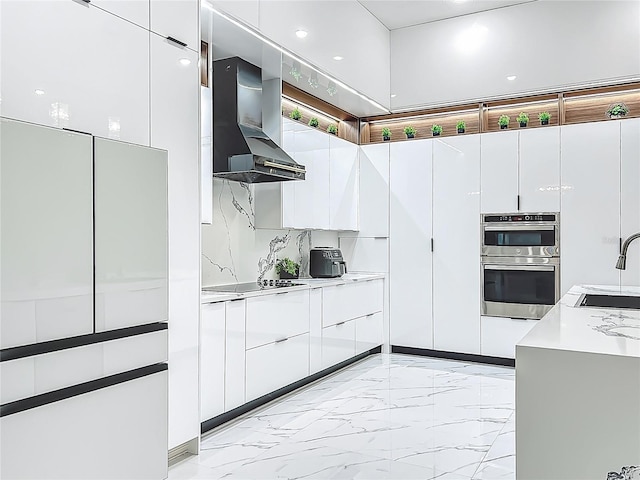 704 Forest View Ct, Winter Springs, FL 32708 - kitchen with wall chimney exhaust hood, double oven, modern cabinets, light countertops, and light marble finish flooring