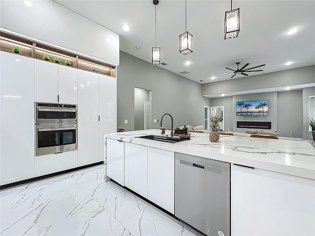 704 Forest View Ct, Winter Springs, FL 32708 - kitchen featuring stainless steel appliances, open floor plan, light marble finish floors, white cabinetry, and pendant lighting