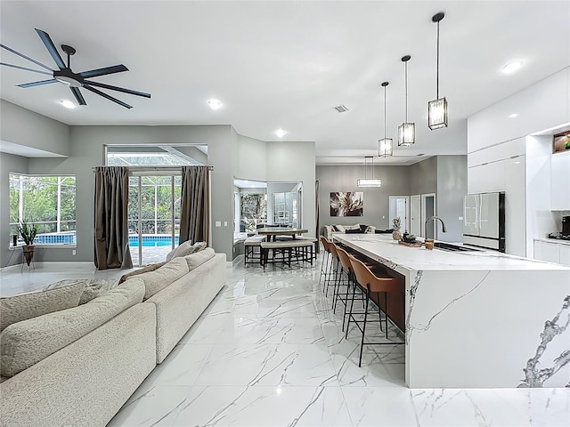 704 Forest View Ct, Winter Springs, FL 32708 - living room with light marble finish flooring, recessed lighting, and ceiling fan