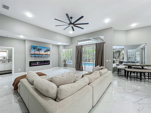 704 Forest View Ct, Winter Springs, FL 32708 - living area featuring light marble finish flooring, a ceiling fan, and recessed lighting