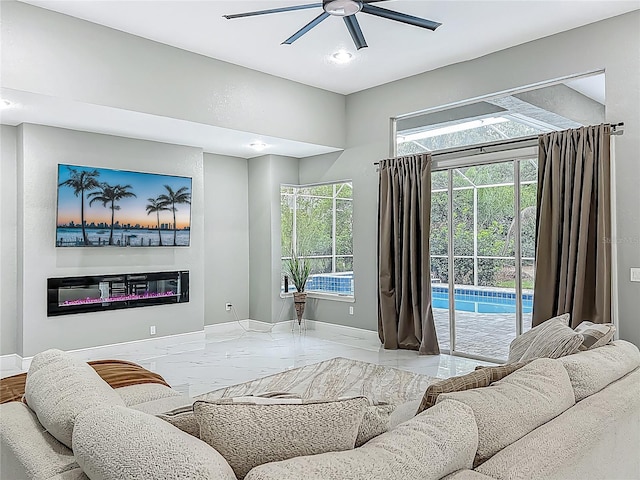 704 Forest View Ct, Winter Springs, FL 32708 - living area with ceiling fan, marble tiled floors, a glass covered fireplace, and recessed lighting