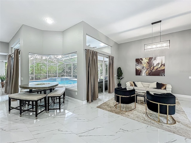 704 Forest View Ct, Winter Springs, FL 32708 - dining room featuring light marble finish flooring and a chandelier