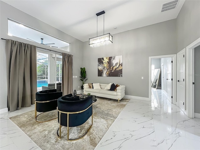 704 Forest View Ct, Winter Springs, FL 32708 - living room with light marble finish floors, a chandelier, and a towering ceiling
