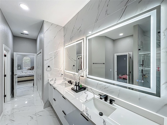 704 Forest View Ct, Winter Springs, FL 32708 - ensuite bathroom featuring double vanity, marble finish floors, and recessed lighting
