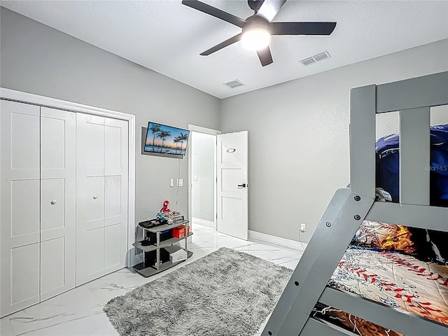704 Forest View Ct, Winter Springs, FL 32708 - bedroom featuring light marble finish floors, a closet, ceiling fan, and a textured ceiling