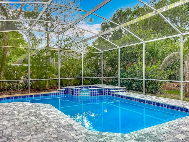 704 Forest View Ct, Winter Springs, FL 32708 - view of swimming pool featuring a pool with connected hot tub, glass enclosure, and a patio area