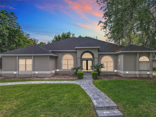 704 Forest View Ct, Winter Springs, FL 32708 - view of front facade featuring stucco siding, a yard, and a shingled roof