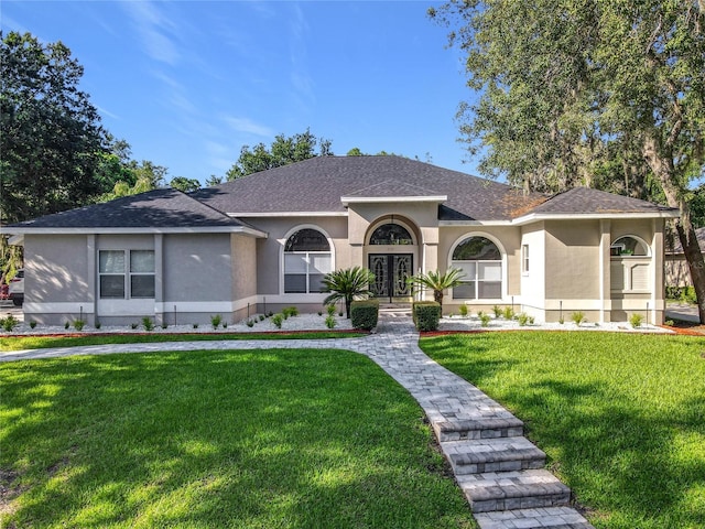 704 Forest View Ct, Winter Springs, FL 32708 - view of front facade with stucco siding, a front lawn, french doors, and a shingled roof