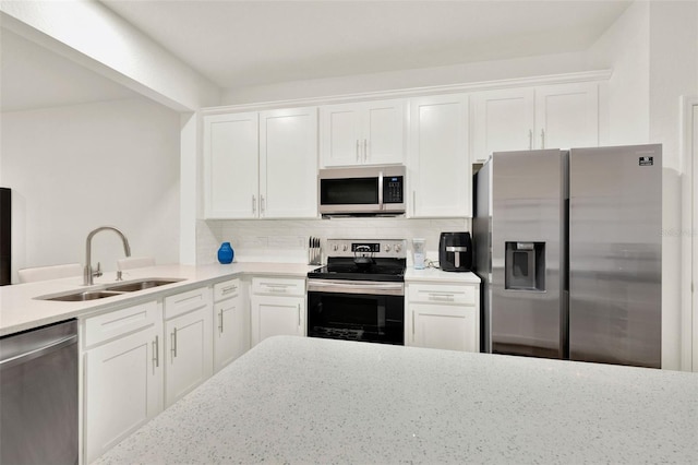 6931 Sperone St, Orlando, FL 32819 - kitchen featuring stainless steel appliances, decorative backsplash, white cabinets, and light stone countertops