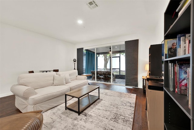6931 Sperone St, Orlando, FL 32819 - living room featuring dark wood-type flooring and recessed lighting
