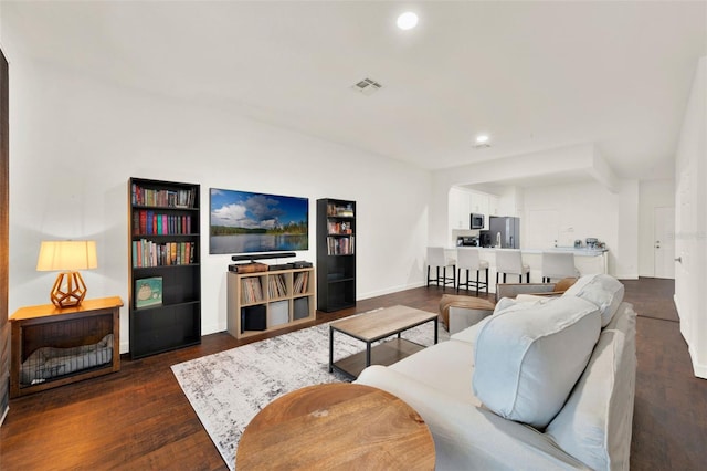 6931 Sperone St, Orlando, FL 32819 - living room with dark wood finished floors and recessed lighting