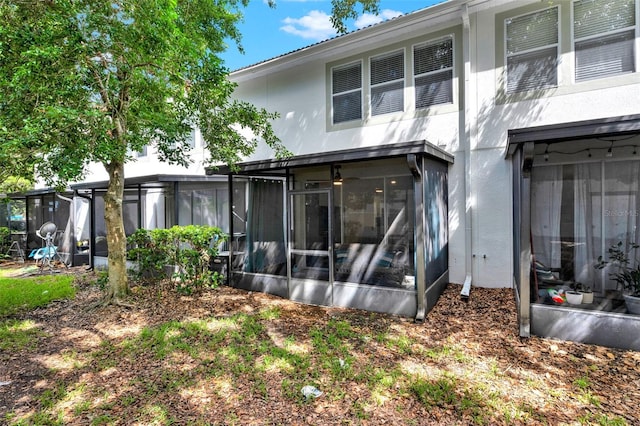 6931 Sperone St, Orlando, FL 32819 - back of property featuring a sunroom and stucco siding