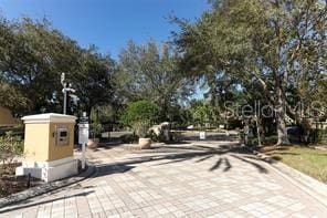 6931 Sperone St, Orlando, FL 32819 - view of street featuring view of scattered trees and curbs