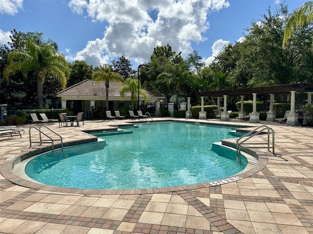 6931 Sperone St, Orlando, FL 32819 - community pool featuring a patio area
