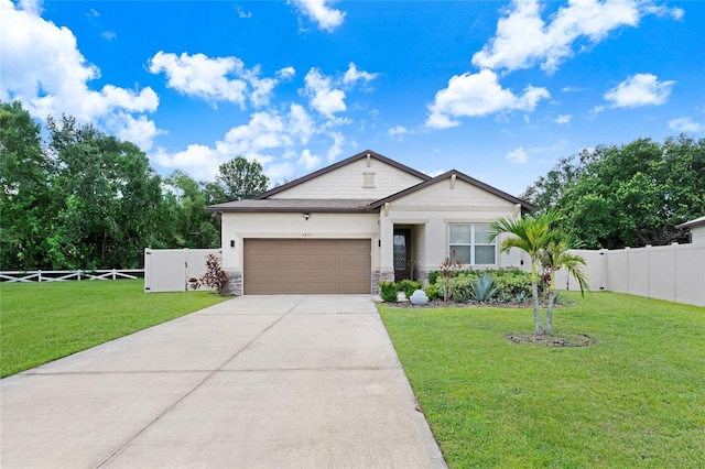 2491 Wadeview Loop, Saint Cloud, FL 34769 - view of front of house with a garage, concrete driveway, and stone siding