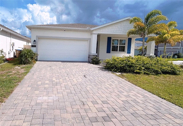 6300 Chirpine Ln, Saint Cloud, FL 34771 - ranch-style home with decorative driveway, stucco siding, an attached garage, and stone siding