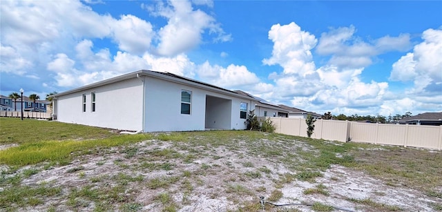 6300 Chirpine Ln, Saint Cloud, FL 34771 - rear view of property with stucco siding