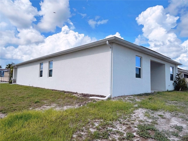 6300 Chirpine Ln, Saint Cloud, FL 34771 - view of property exterior featuring stucco siding and a yard