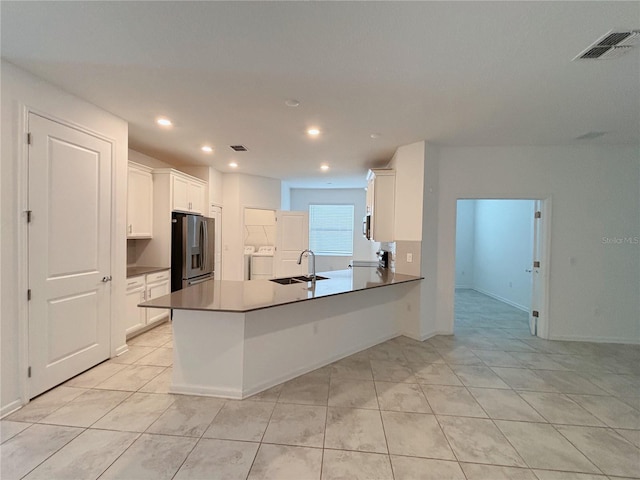 6300 Chirpine Ln, Saint Cloud, FL 34771 - kitchen featuring appliances with stainless steel finishes, washer / dryer, white cabinetry, light tile patterned flooring, and recessed lighting