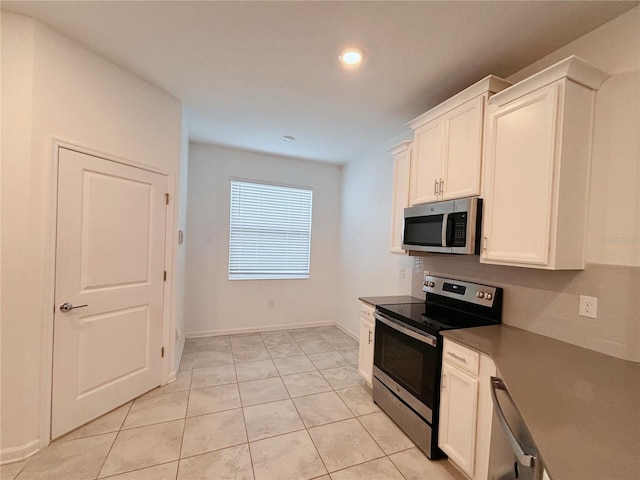 6300 Chirpine Ln, Saint Cloud, FL 34771 - kitchen with stainless steel appliances, backsplash, recessed lighting, white cabinets, and light tile patterned floors