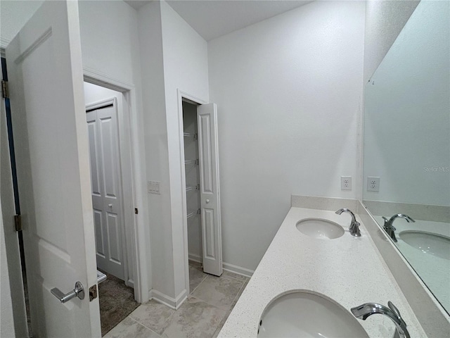6300 Chirpine Ln, Saint Cloud, FL 34771 - bathroom featuring double vanity and a spacious closet