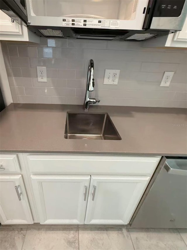 6300 Chirpine Ln, Saint Cloud, FL 34771 - kitchen featuring white cabinets and backsplash