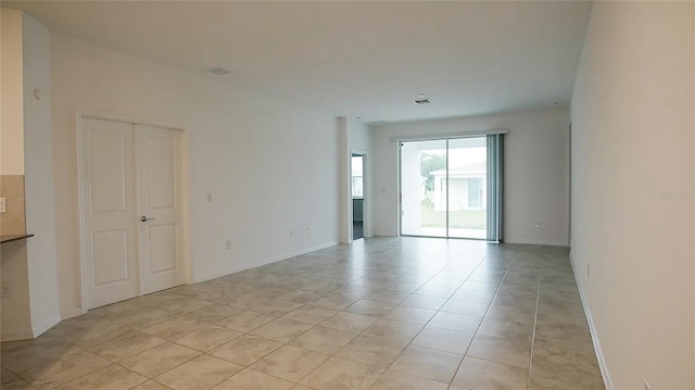 6300 Chirpine Ln, Saint Cloud, FL 34771 - empty room with light tile patterned floors and baseboards