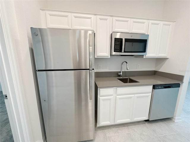 6300 Chirpine Ln, Saint Cloud, FL 34771 - kitchen with appliances with stainless steel finishes and white cabinetry