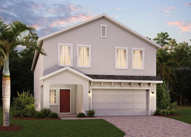 317 Preserve Pointe Blvd, Davenport, FL 33837 - mediterranean / spanish-style house featuring decorative driveway, a garage, stucco siding, and a yard